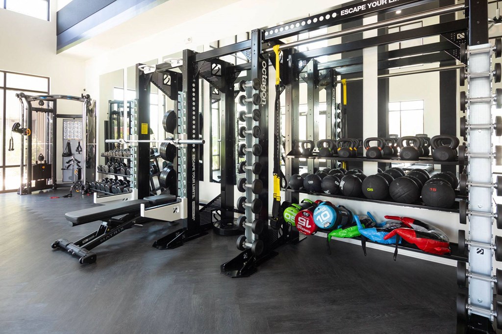 a gym with weights and other equipment in it