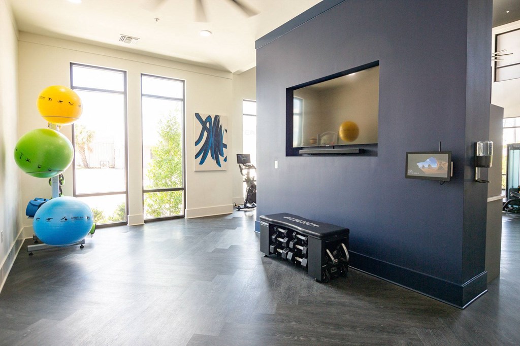 a living room with a blue wall and a tv and some balloons