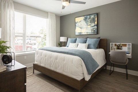 a bedroom with a large bed and a window