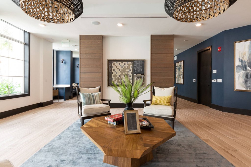 a lobby of a hotel with a coffee table and chairs