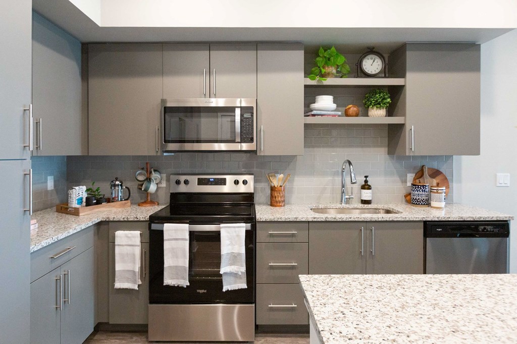 a kitchen with stainless steel appliances and granite counter tops