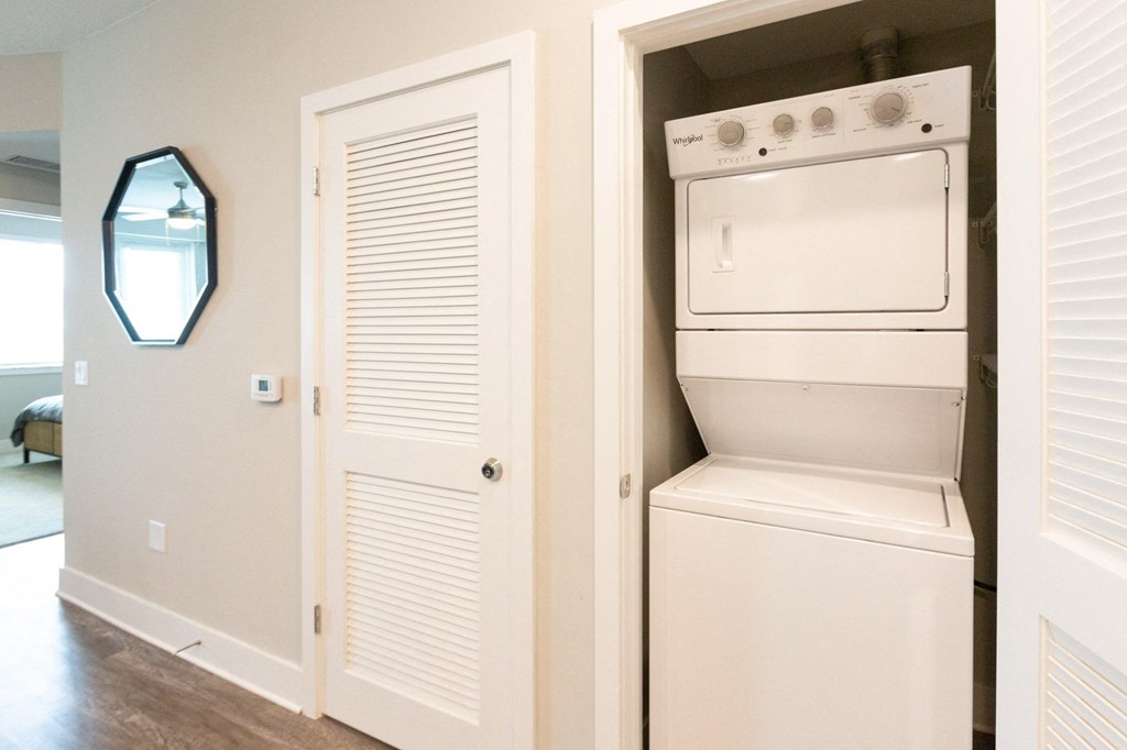 an empty laundry room with a washer and dryer