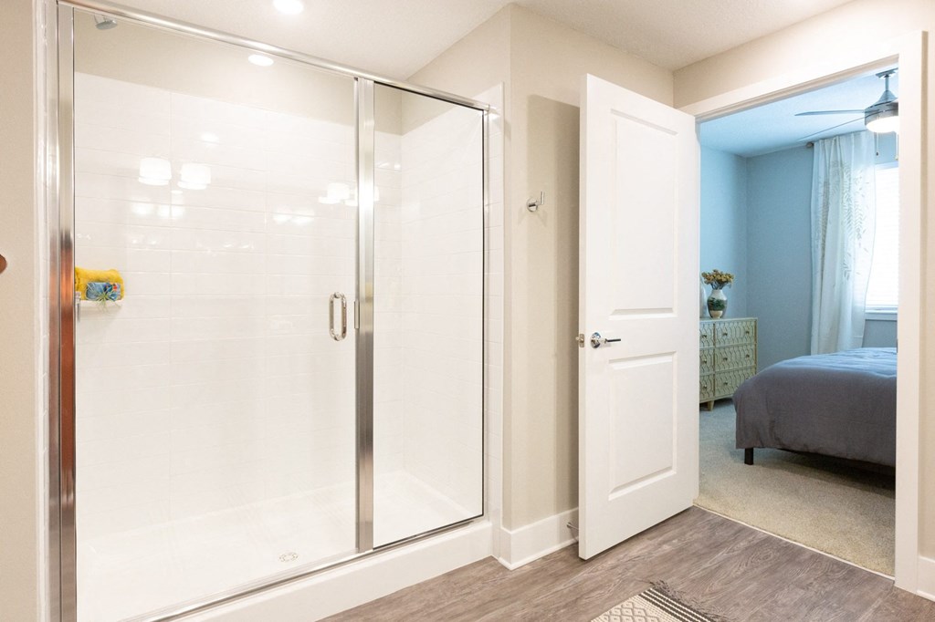 a bathroom with a shower and a bed