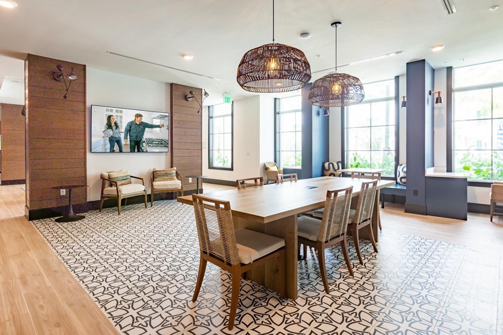 a large dining room with a wooden table and chairs
