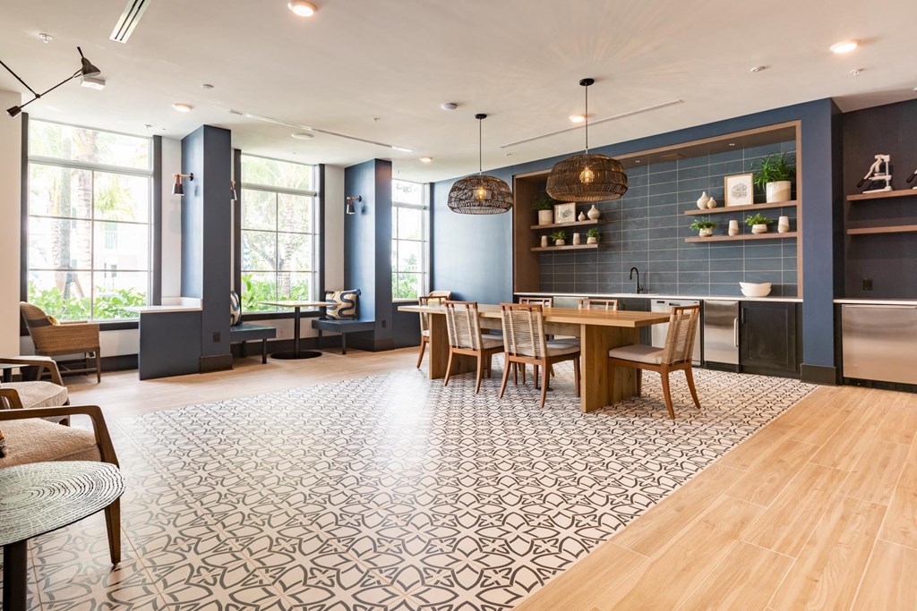 a dining room with blue walls and a table and chairs