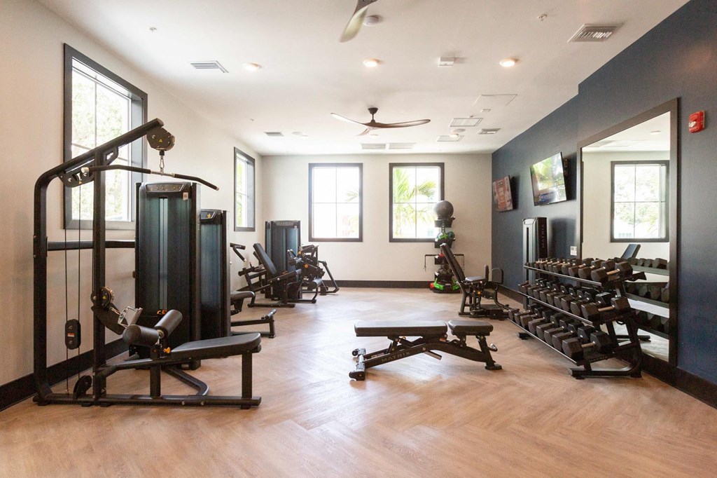 a fitness room with weights and other exercise equipment