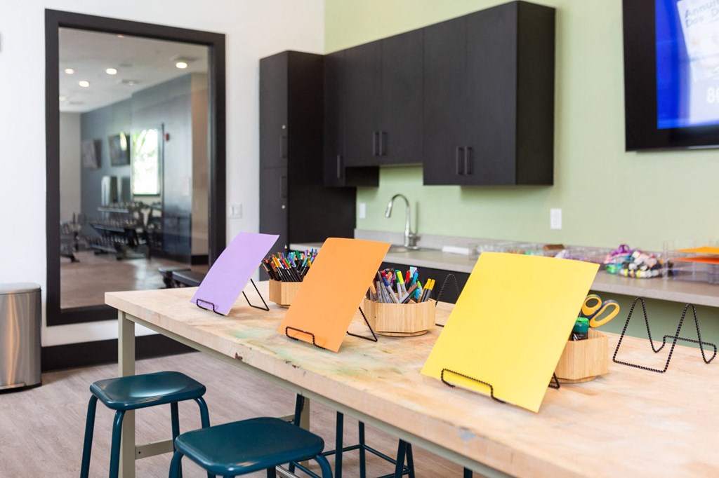 a kitchen with a table with yellow and purple paper on it