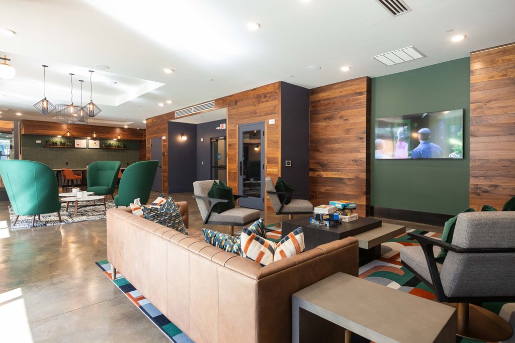 a living room with a couch and chairs and a television