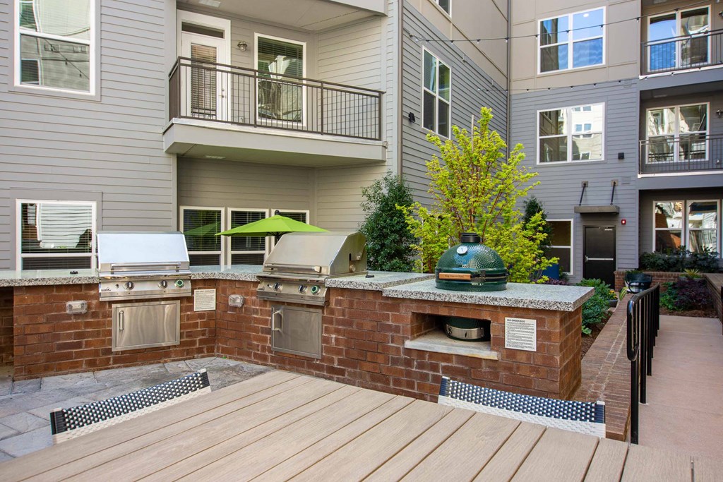 a large outdoor kitchen with a wooden deck