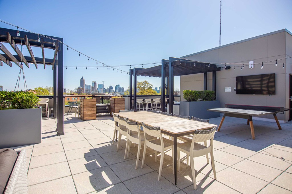 a patio with a table and chairs on a roof