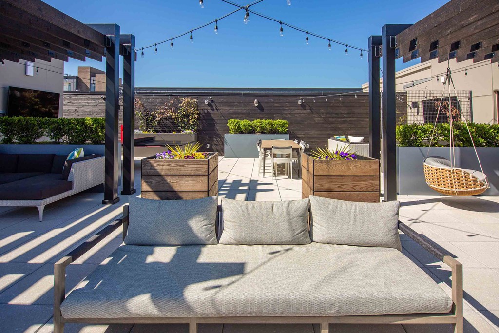 a patio with a couch and pillows on a