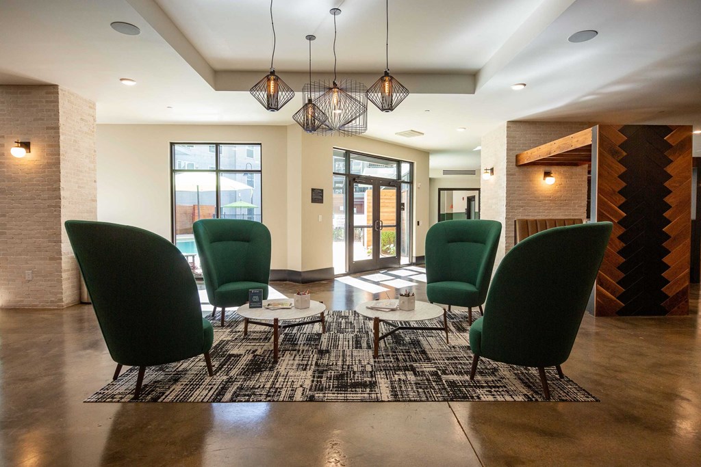 a seating area in a lobby with chairs and tables