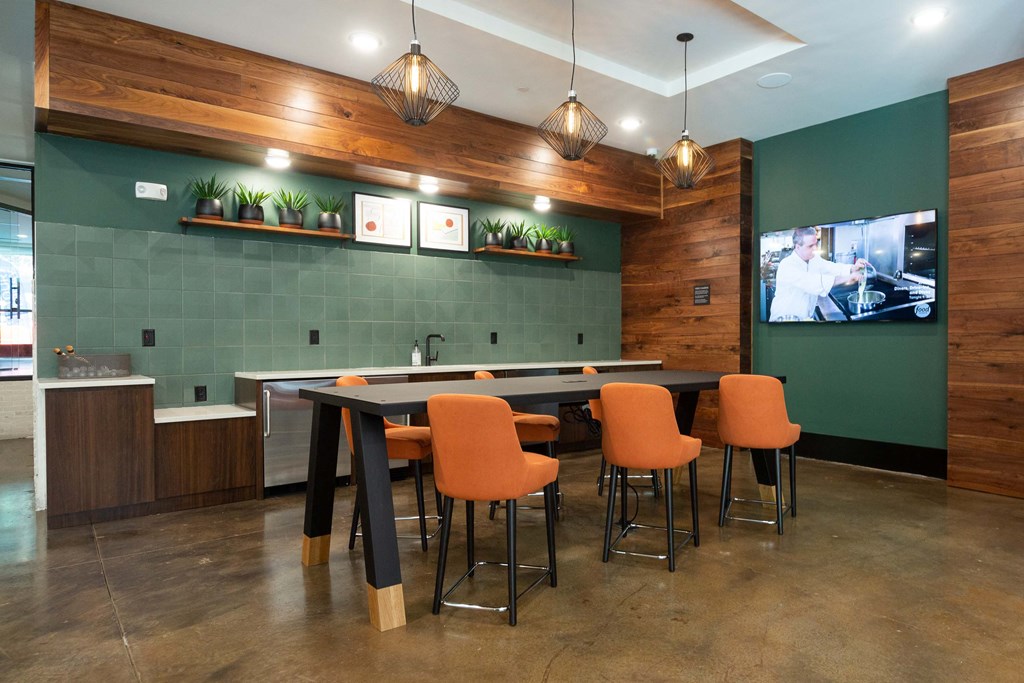 a conference room with a table and chairs and a tv