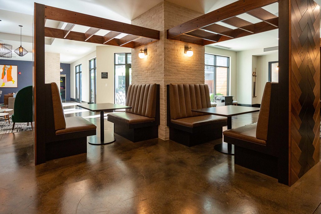 a seating area with chairs and tables in a lobby