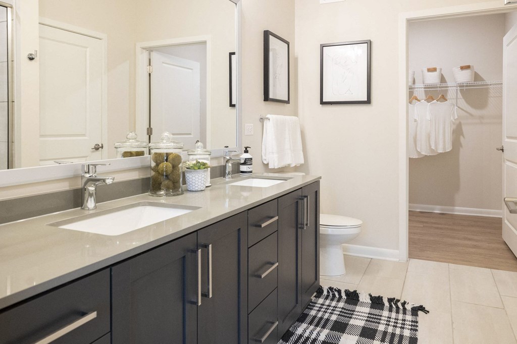 a black and white bathroom with two sinks and a toilet