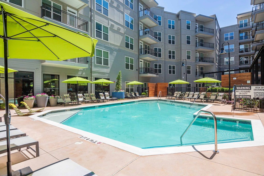 a swimming pool in front of an apartment building