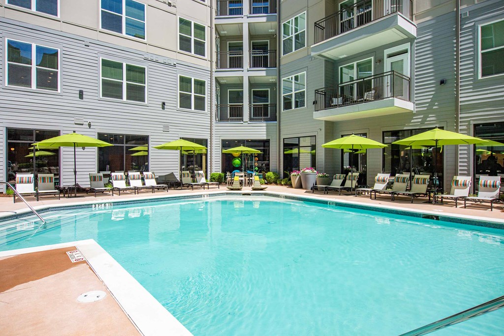 a swimming pool in a building with umbrellas