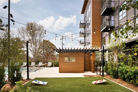a small backyard with a pool and a wooden shed