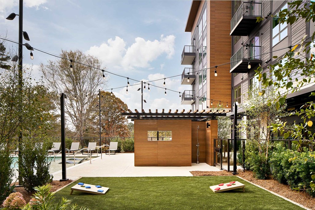 a small backyard with a pool and a wooden shed