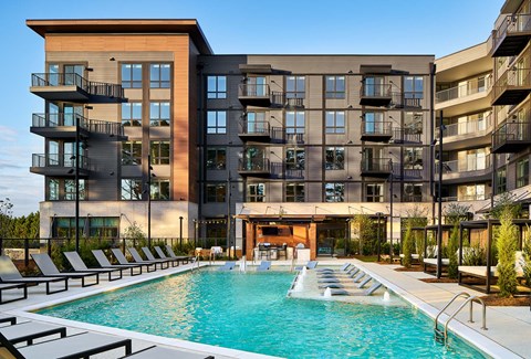 a swimming pool in front of an apartment building