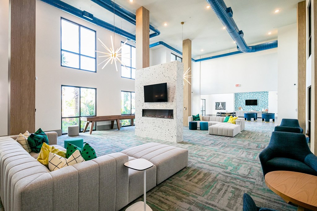 a large living room with couches and chairs and a fireplace