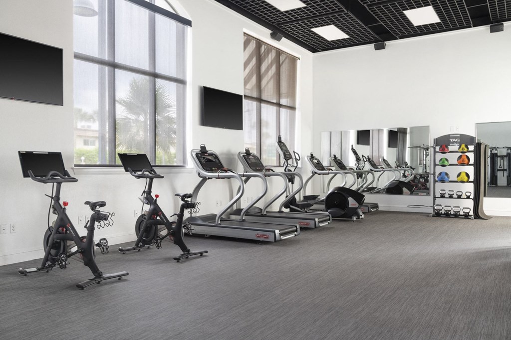 a row of exercise bikes in a gym