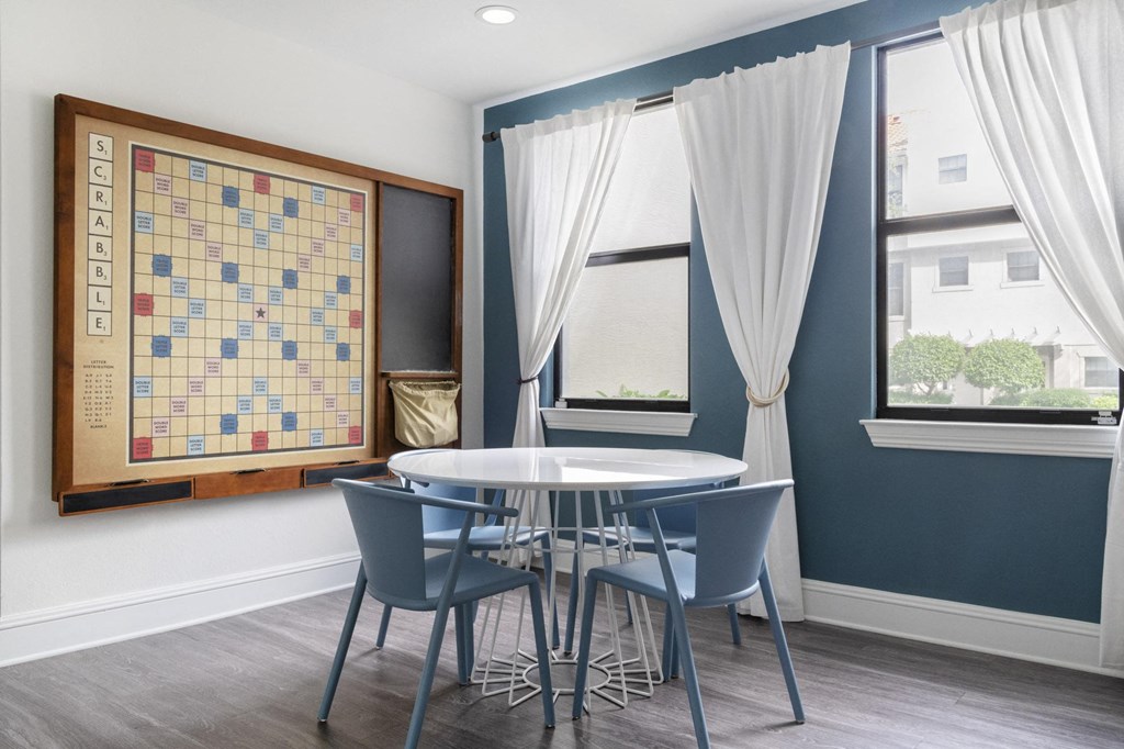 a dining room with a table and chairs and a bulletin board