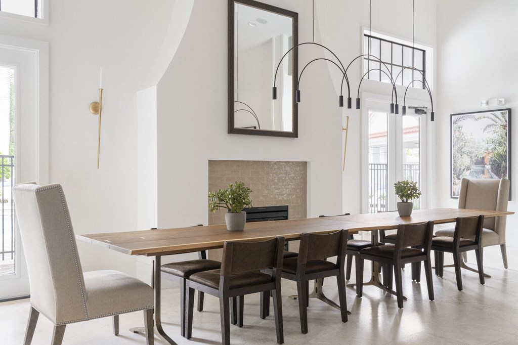 a dining room with a wooden table and chairs and a fireplace