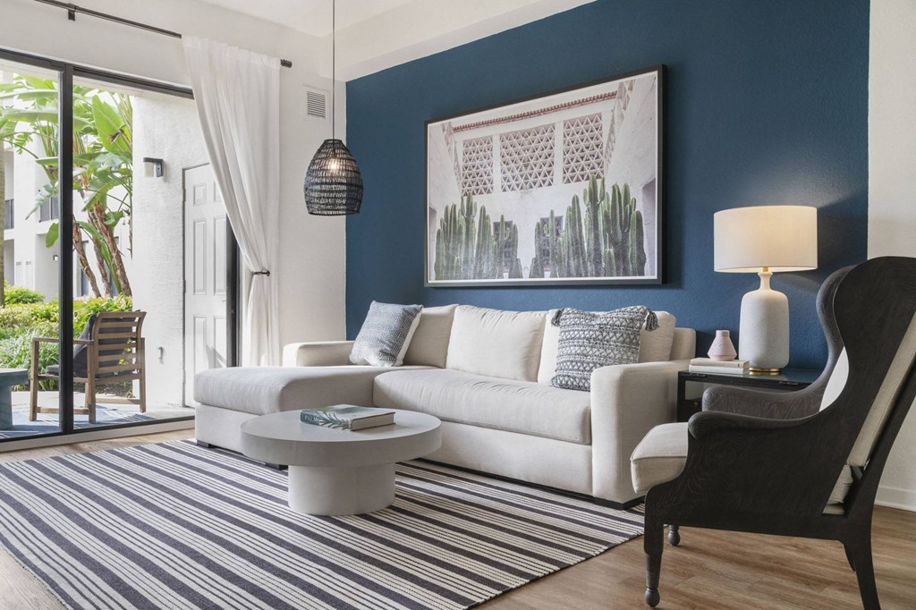a living room with blue walls and a white couch and a table