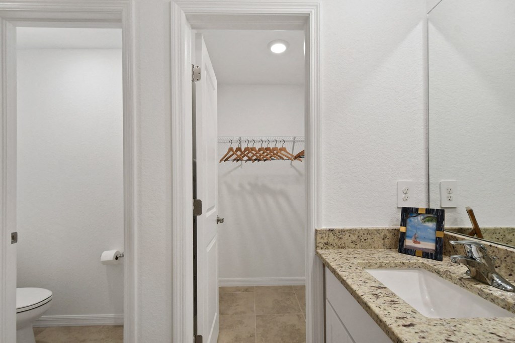 a bathroom with a sink and a toilet and a shower