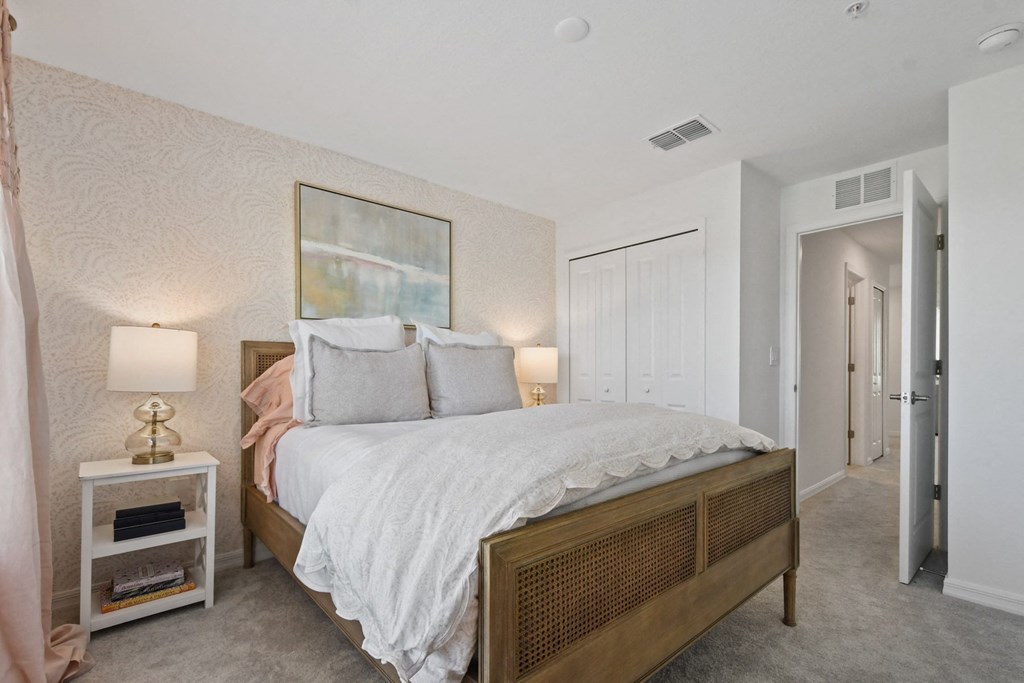 a bedroom with a bed and a night stand with lamps