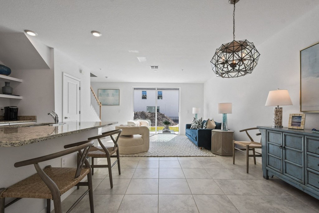 a living room with a bar and a dining room
