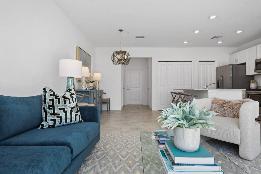a living room with a blue couch and a rug