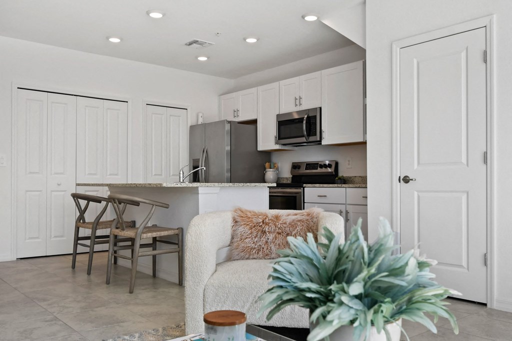 an open kitchen and living room with a couch and a table