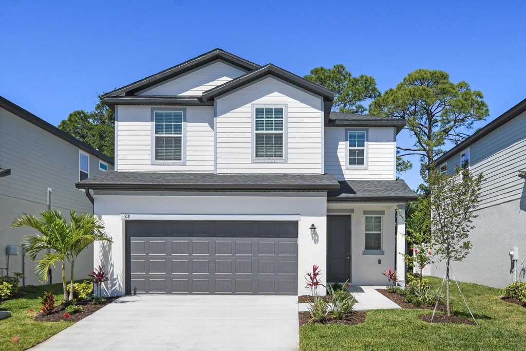 a white house with a garage door