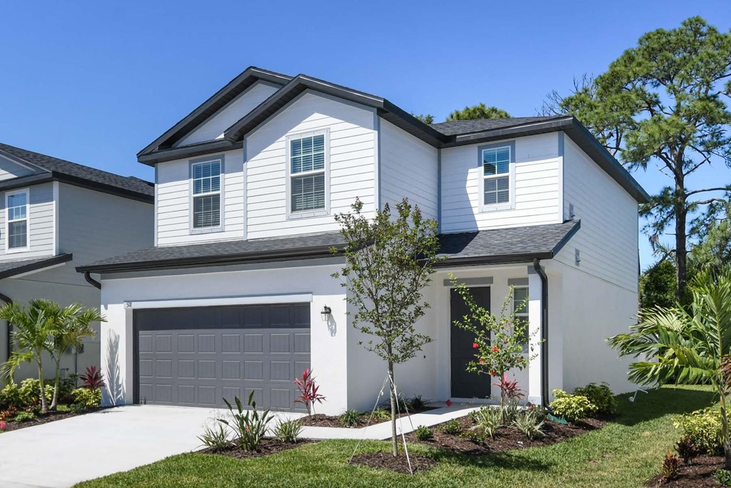 a white house with a garage door