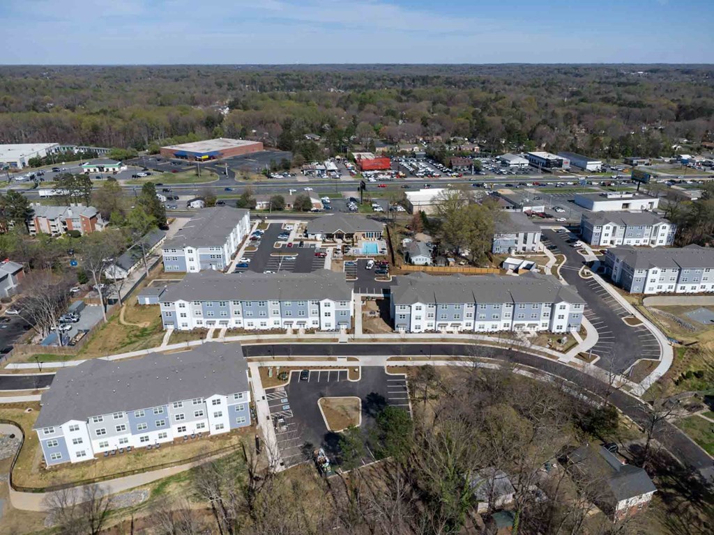 an aerial view of a city with houses and a parking lot