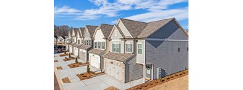 exterior townhomes with driveways on sunny day
