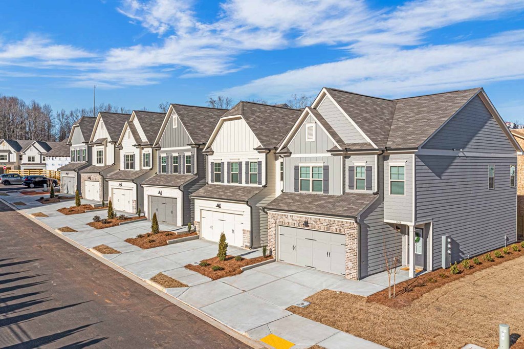 a row of houses with garage doors