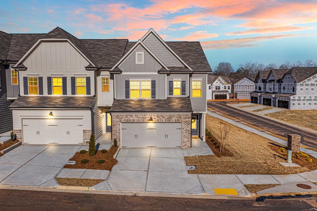 a house with two garage doors on a street