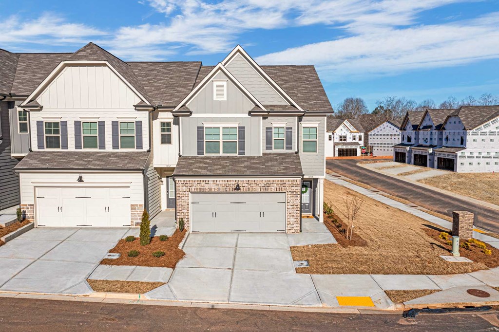 a house with two garage doors on a street