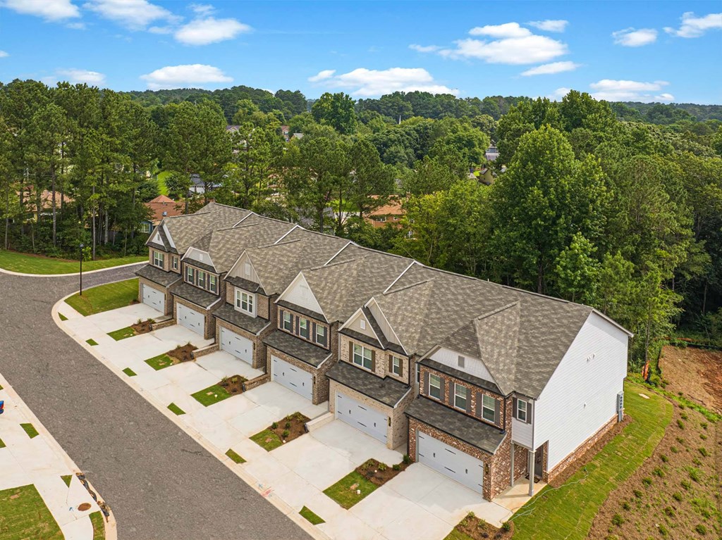 a large house with a gray roof and some trees