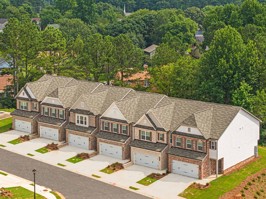 an aerial view of a house with a gray roof