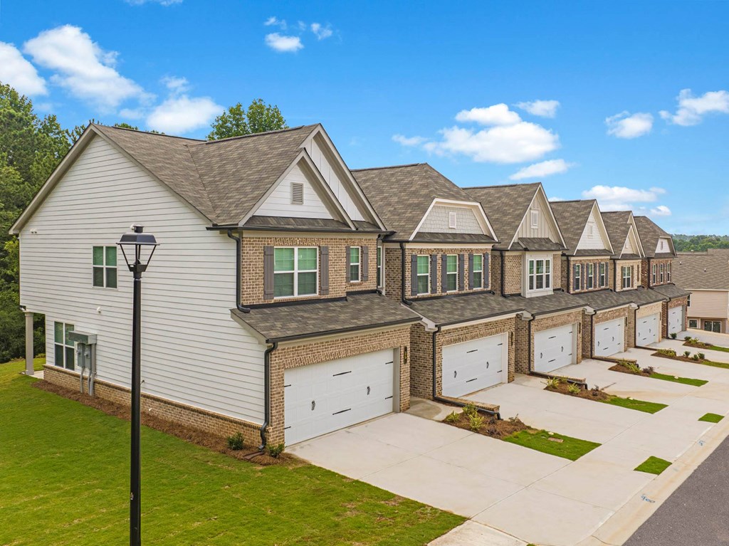 a row of houses with garage doors