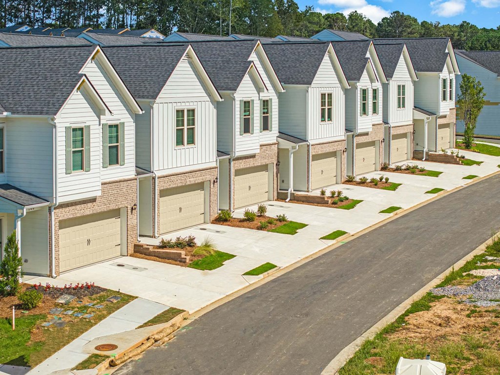 an aerial view of a row of houses in a street