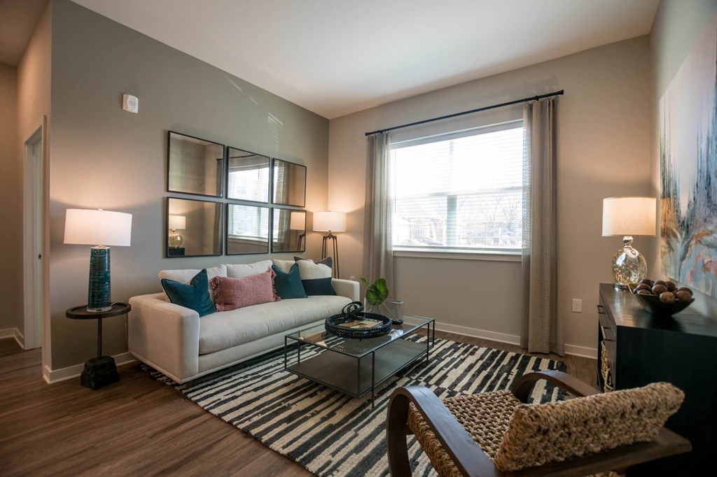 a living room with a white couch and a glass coffee table