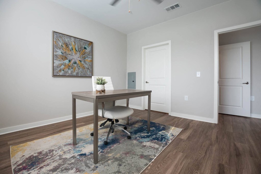 a home office with a desk and a door