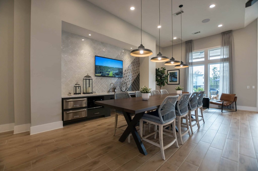 a dining room with a wooden table and chairs
