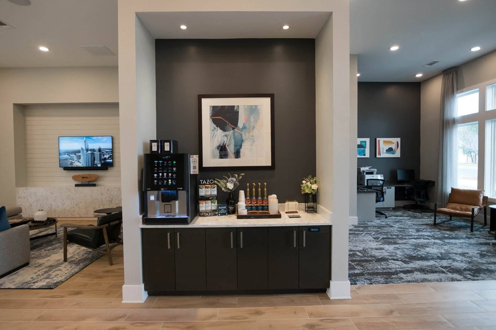 a lobby with a coffee bar and a living room with a television