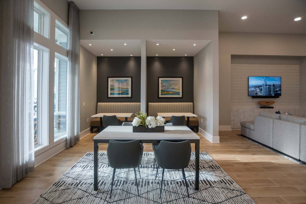 a dining room with a table and chairs and a television